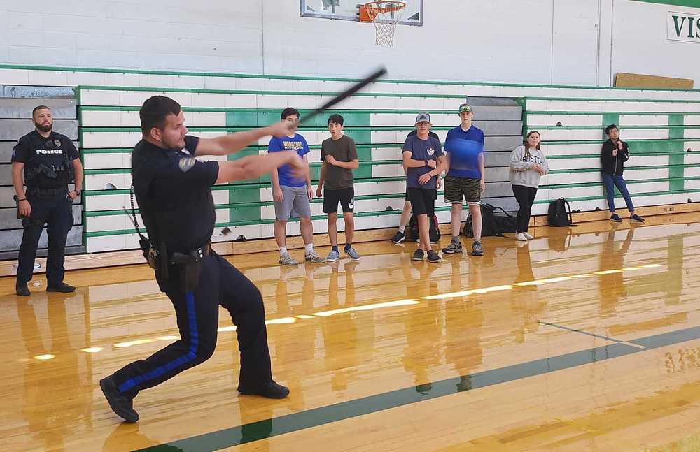 Officer Rhoden swings the bat at PHS